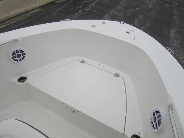 Slide: The Image of 2024 Robalo R180 Center Console boat bow with storage compartments and speakers. - 12