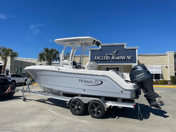 Slide: The Image of 2024 Robalo R222 Explorer boat on trailer at Anglers Marine NC. - 1