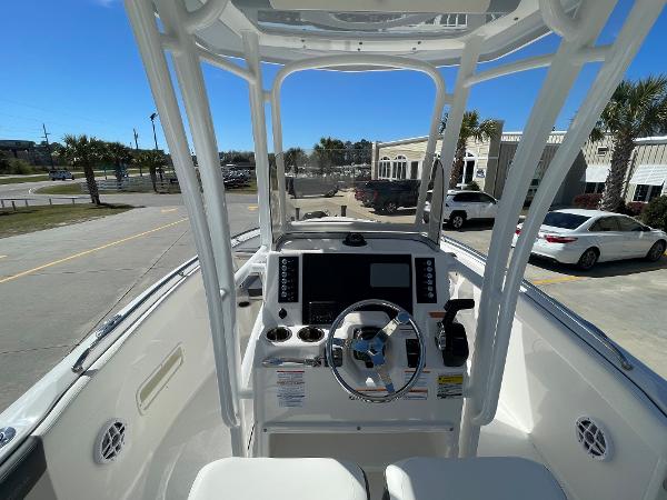 Slide: The Image of 2024 Robalo R222 Explorer boat cockpit with steering wheel and control panel. - 10