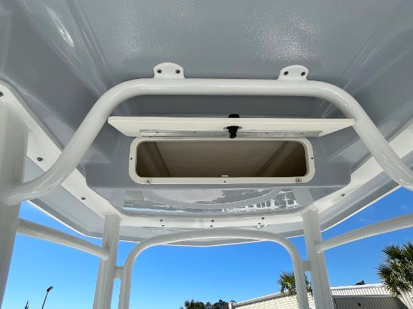 Slide: The Image of 2024 Robalo R222 Explorer boat storage compartment under T-top. - 11