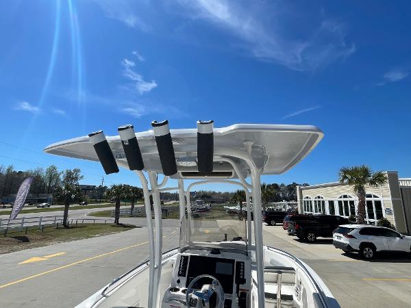 Slide: The Image of 2024 Robalo R222 Explorer boat with T-top and rod holders under clear blue sky. - 12