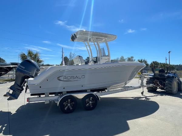 Slide: The Image of 2024 Robalo R222 Explorer boat on trailer, side view, sunny day. - 3