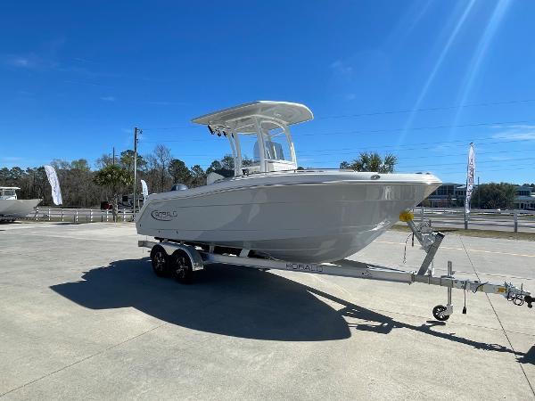 Slide: The Image of 2024 Robalo R222 Explorer boat on a trailer under a clear blue sky. - 4