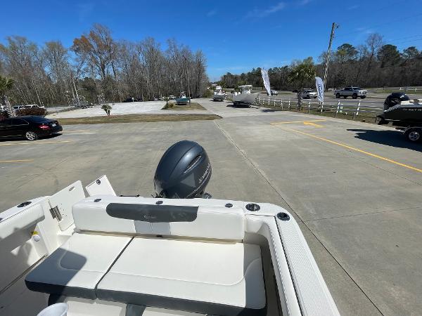 Slide: The Image of 2024 Robalo R222 Explorer boat with outboard motor in parking lot. - 9