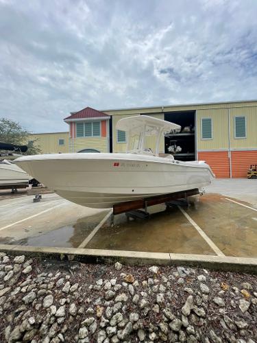 Slide: The Image of 2019 Robalo R242 Center Console boat on a trailer outside a storage facility. - 0
