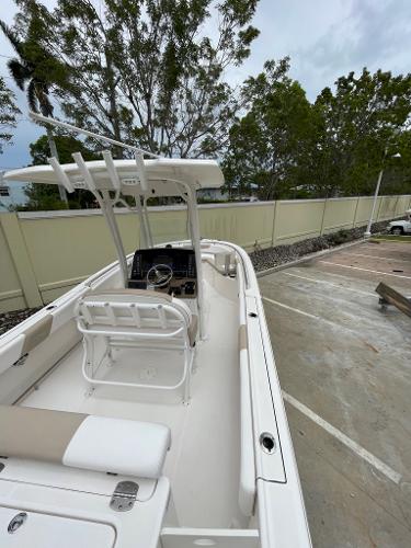 Slide: The Image of 2019 Robalo R242 Center Console boat in a parking lot. - 14