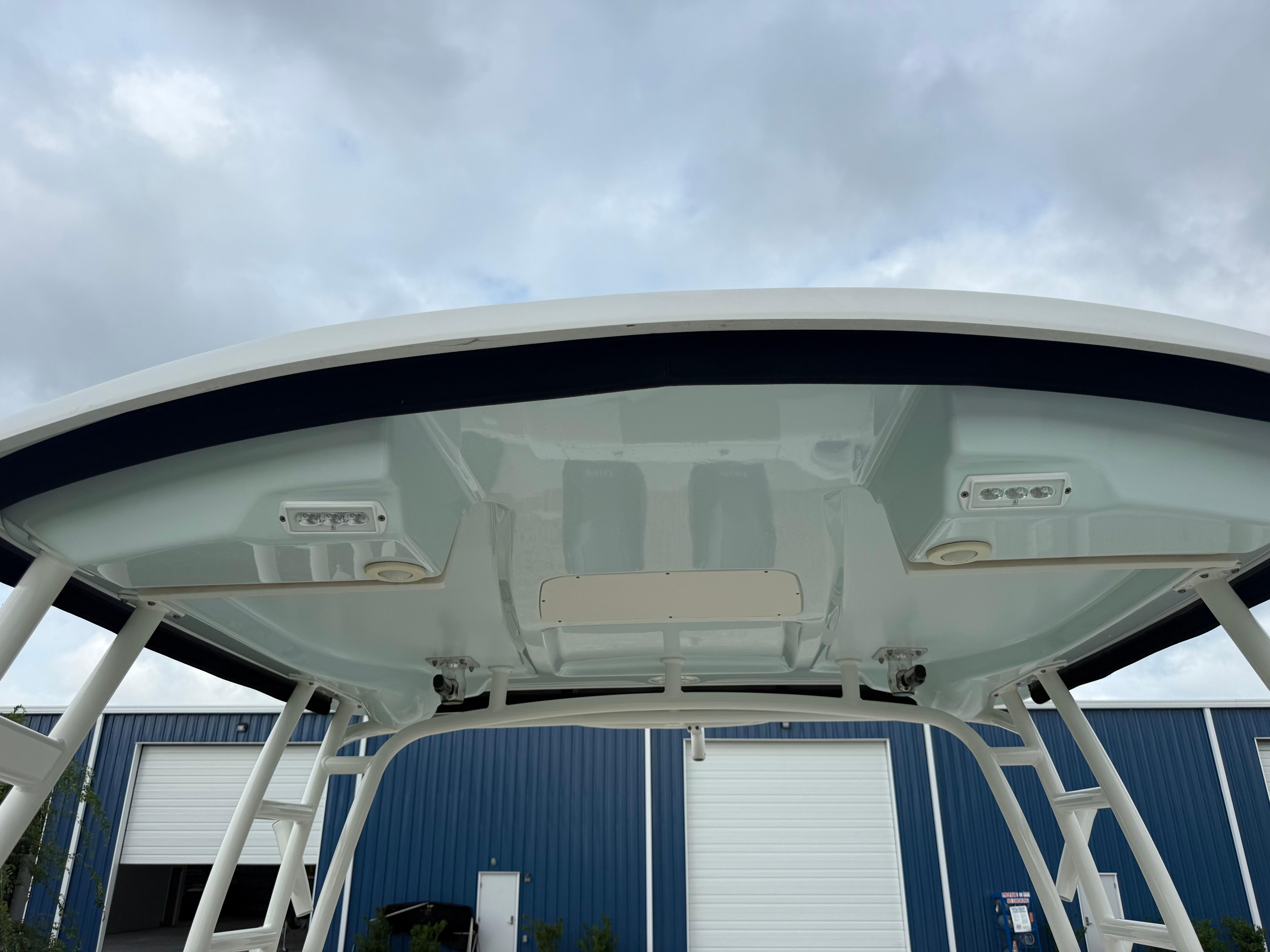 Slide: The Image of 2018 Robalo R247 Dual Console boat top view with blue sky background. - 12