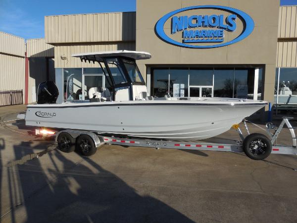 Slide: The Image of 2024 Robalo R266 Cayman boat on trailer at Nichols Marine dealership. - 1