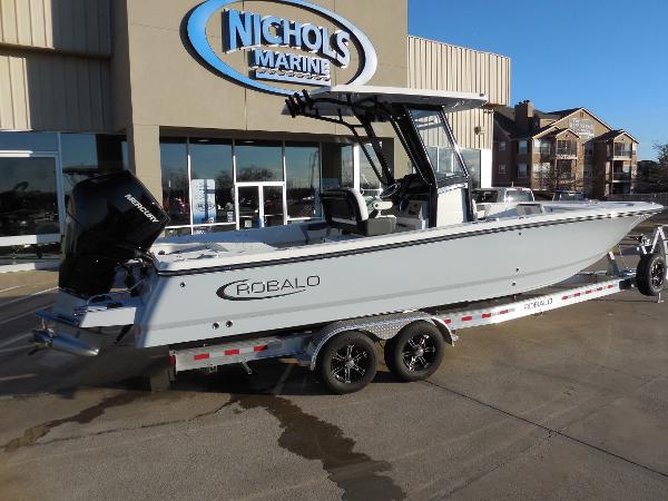 Slide: The Image of 2024 Robalo R266 Cayman boat on trailer at Nichols Marine dealership. - 2