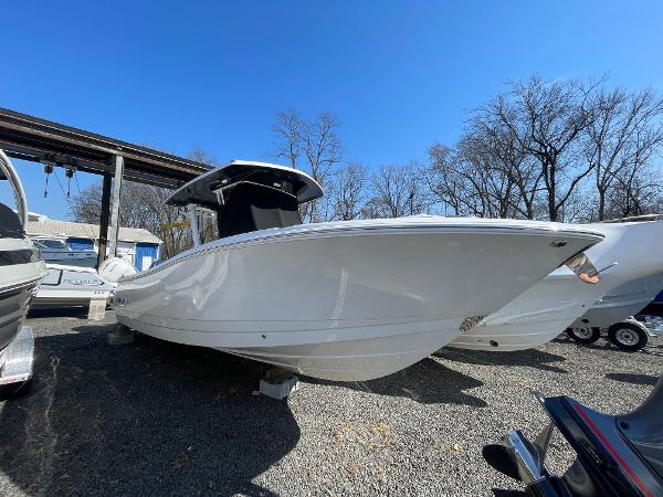 Slide: The Image of 2024 Robalo R270 Center Console boat displayed outdoors under clear blue sky. - 0