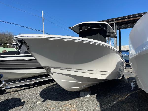 Slide: The Image of 2024 Robalo R270 Center Console boat displayed outdoors under clear blue sky. - 1