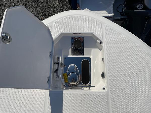 Slide: The Image of 2024 Robalo R270 Center Console boat anchor compartment with open hatch. - 11