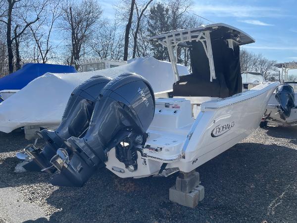 Slide: The Image of 2024 Robalo R270 Center Console boat with dual engines, parked outdoors. - 3