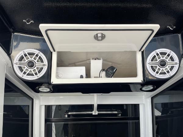 Slide: The Image of 2024 Robalo R270 Center Console audio system with storage compartment and speakers. - 8