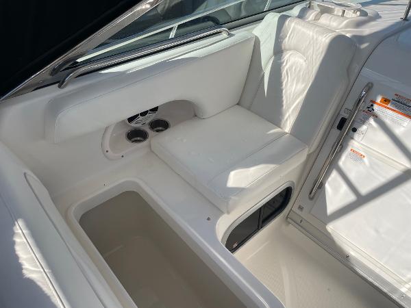 Slide: The Image of 2009 Robalo R305 Walkaround interior with white seating and storage compartments. - 19