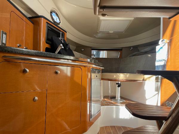 Slide: The Image of 2009 Robalo R305 Walkaround cabin interior with wood cabinetry and seating area. - 40