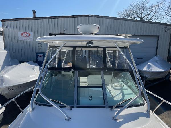 Slide: The Image of 2009 Robalo R305 Walkaround boat docked near a storage facility. - 49