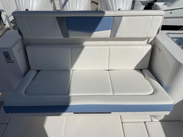 Slide: The Image of 2024 Robalo R360 boat with white and blue cushioned seating. - 12