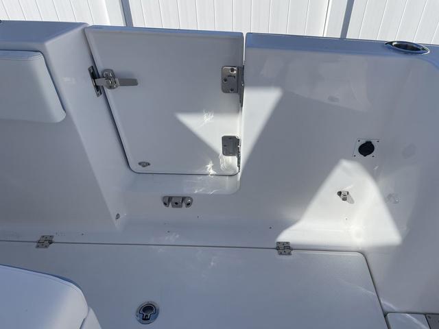 Slide: The Image of 2024 Robalo R360 boat interior with storage compartment and clean white finish. - 16