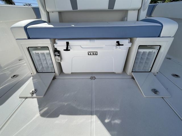 Slide: The Image of 2024 Robalo R360 boat with Yeti cooler and storage compartments. - 18