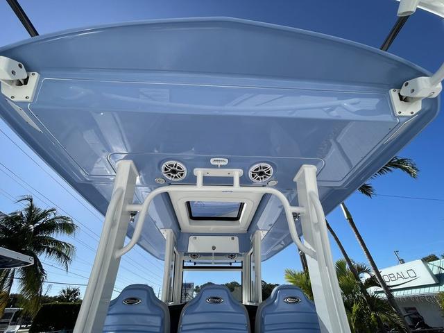 Slide: The Image of 2024 Robalo R360 boat with blue hardtop and seating. - 19