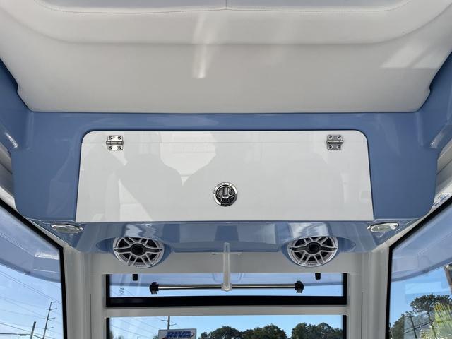 Slide: The Image of 2024 Robalo R360 boat interior with overhead storage and speakers. - 23