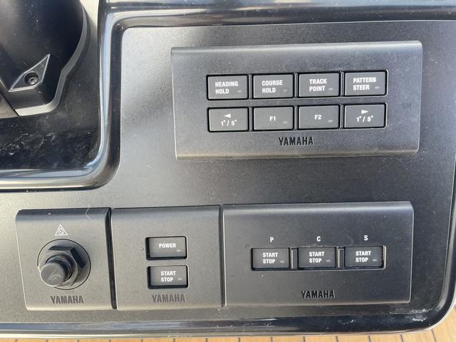 Slide: The Image of Yamaha control panel on 2024 Robalo R360 boat with various function buttons. - 32