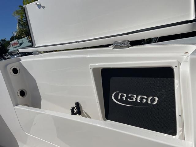 Slide: The Image of 2024 Robalo R360 boat detail with storage compartment and logo. - 35