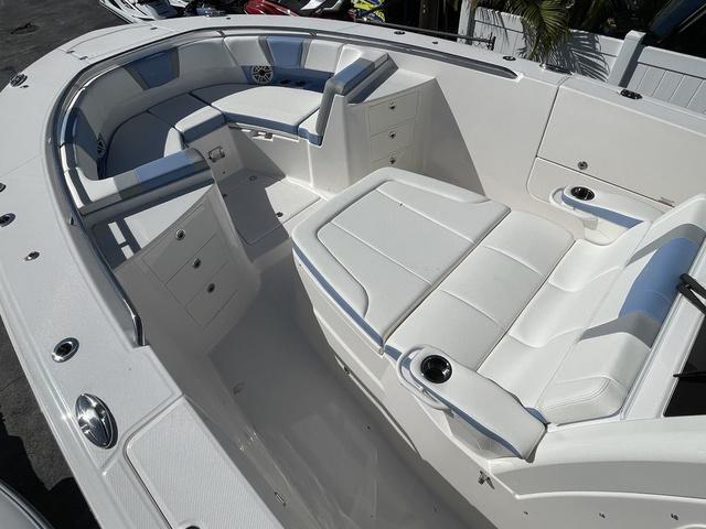 Slide: The Image of 2024 Robalo R360 boat interior with white seating and storage compartments. - 36
