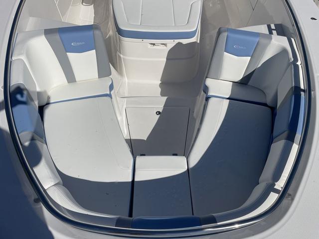 Slide: The Image of 2024 Robalo R360 boat interior with white and blue cushioned seating. - 39