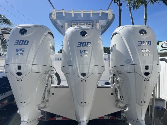 Slide: The Image of 2024 Robalo R360 boat with triple 300 HP V6 4.2L outboard engines. - 4