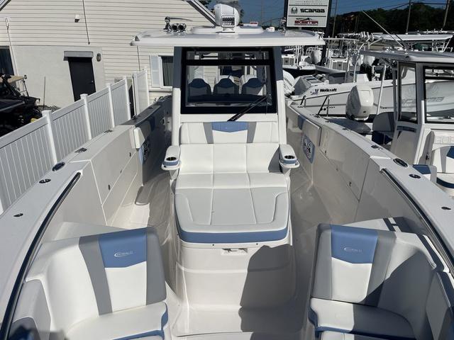Slide: The Image of 2024 Robalo R360 boat with white and blue seating in a marina. - 40