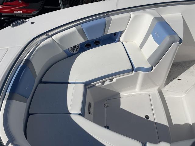 Slide: The Image of 2024 Robalo R360 boat interior seating area with white and blue cushions. - 41