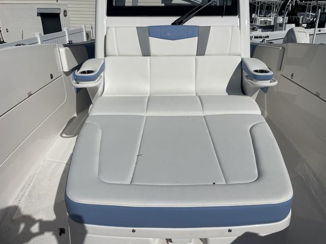 Slide: The Image of 2024 Robalo R360 boat with white and blue cushioned seating. - 46