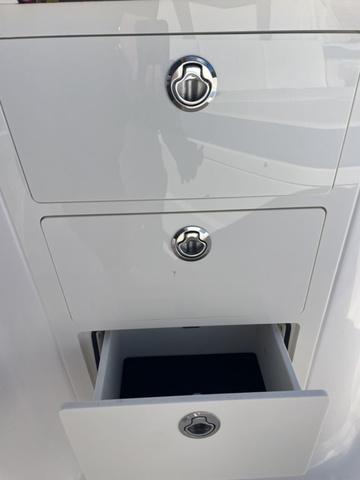 Slide: The Image of 2024 Robalo R360 boat storage drawers with chrome handles. - 48