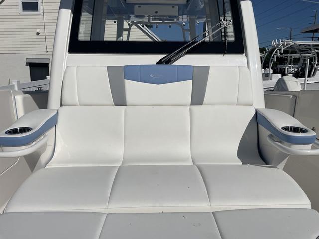 Slide: The Image of 2024 Robalo R360 boat with white and blue cushioned seating. - 49