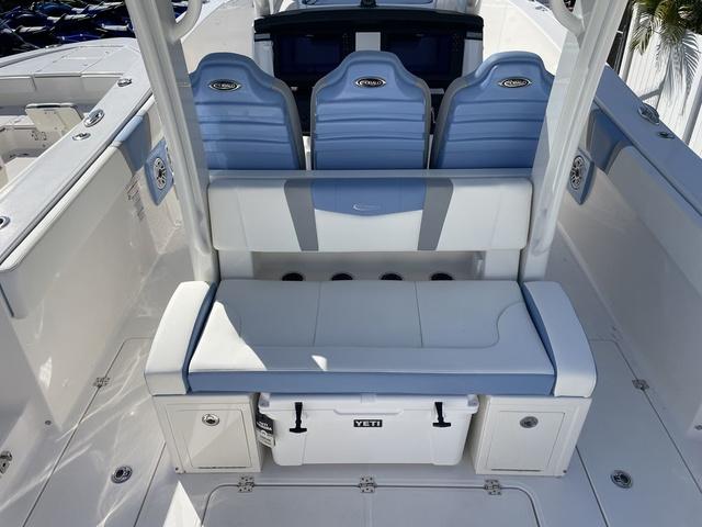 Slide: The Image of 2024 Robalo R360 boat interior with blue and white seating and Yeti cooler. - 7