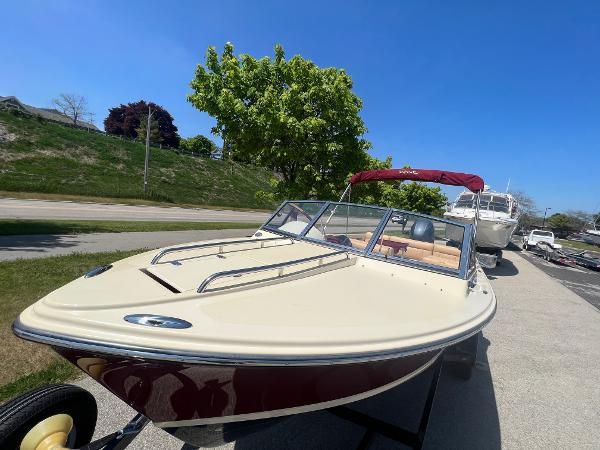 Slide: The Image of 2021 Rossiter 20 Coastal Cruiser boat on a trailer, parked outdoors. - 11