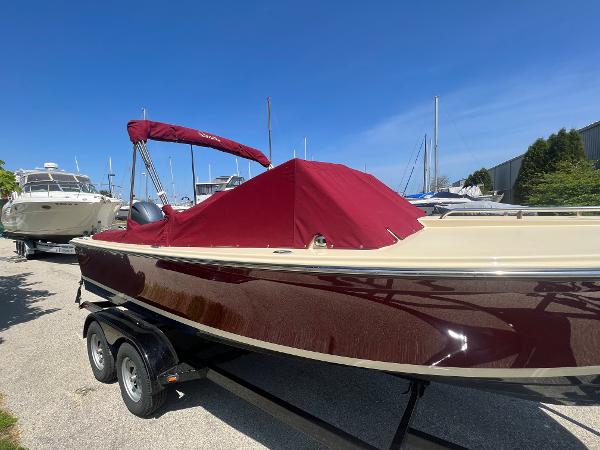 Slide: The Image of 2021 Rossiter 20 Coastal Cruiser boat with maroon cover on trailer. - 13