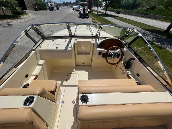 Slide: The Image of 2021 Rossiter 20 Coastal Cruiser boat interior with tan seating and steering wheel. - 19