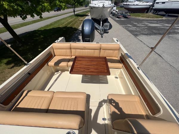 Slide: The Image of 2021 Rossiter 20 Coastal Cruiser with tan seating and wooden table. - 20
