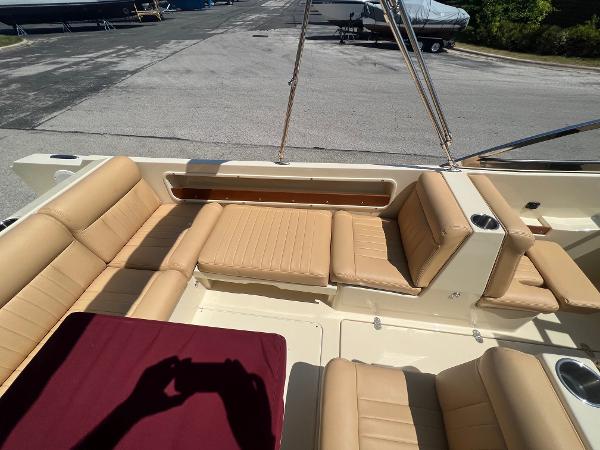 Slide: The Image of 2021 Rossiter 20 Coastal Cruiser with tan leather seating in a marina. - 21