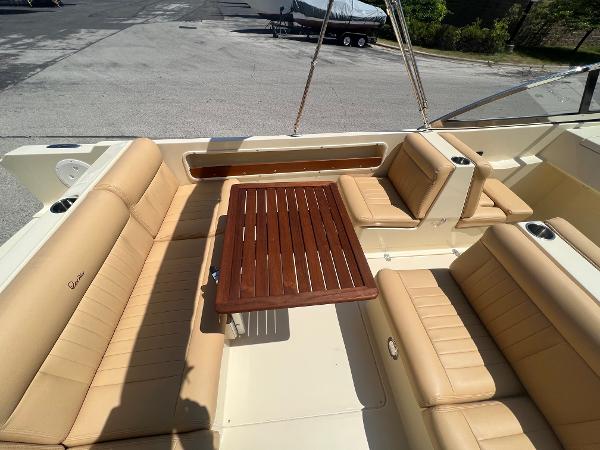 Slide: The Image of 2021 Rossiter 20 Coastal Cruiser with tan leather seating and wooden table. - 24