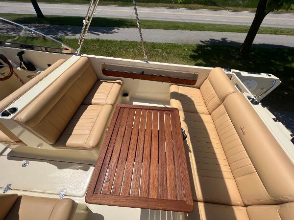 Slide: The Image of 2021 Rossiter 20 Coastal Cruiser with tan leather seating and wooden table. - 26