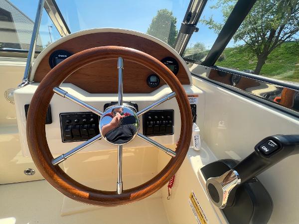 Slide: The Image of 2021 Rossiter 20 Coastal Cruiser steering wheel and control panel. - 28