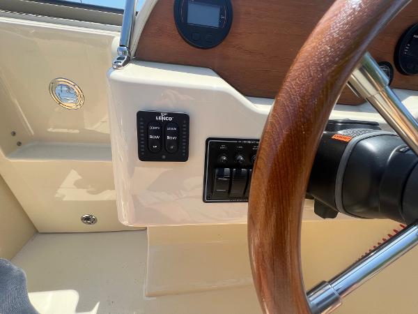 Slide: The Image of 2021 Rossiter 20 Coastal Cruiser dashboard with wooden steering wheel and control panel. - 32