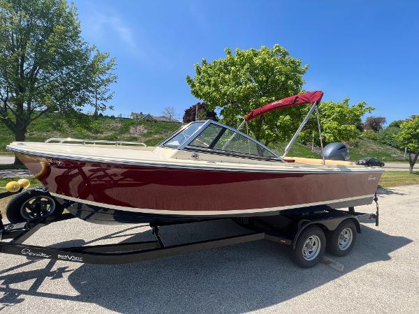 Slide: The Image of 2021 Rossiter 20 Coastal Cruiser boat on a trailer with a red canopy. - 7