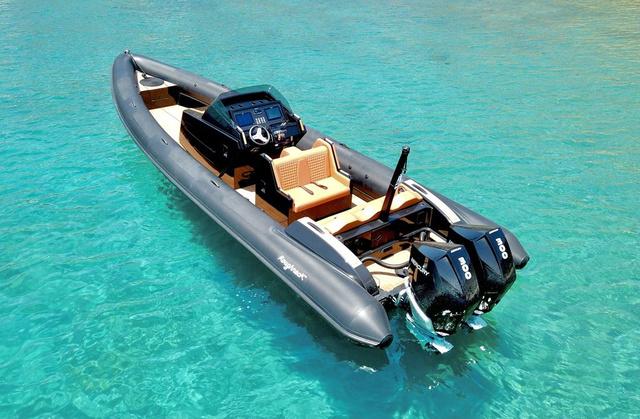 Slide: The Image of 2022 Roughneck RIB 1010 boat on clear turquoise water, featuring dual engines and sleek design. - 11