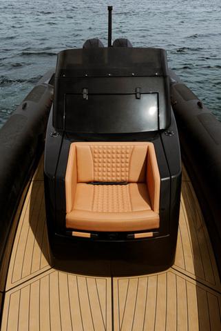 Slide: The Image of Roughneck RIB 1010 boat, 2022 model, featuring sleek design and tan seating on open water. - 15