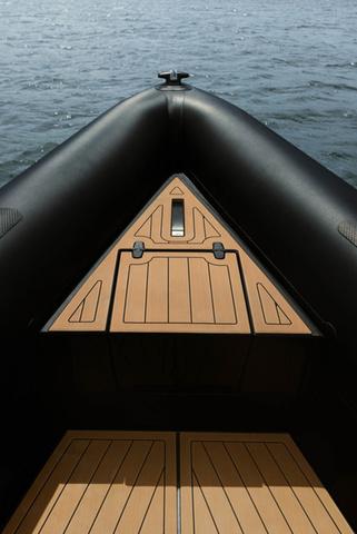 Slide: The Image of Roughneck RIB 1010 boat, 2022 model, featuring a sleek black and wood design on water. - 19